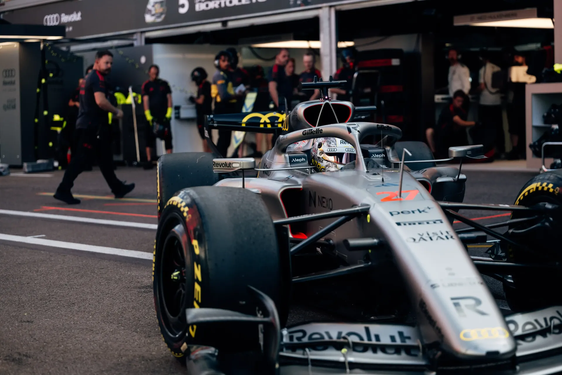 Audi Revolut F1® Team Formula 1 car being pushed through the pit lane by mechanics.