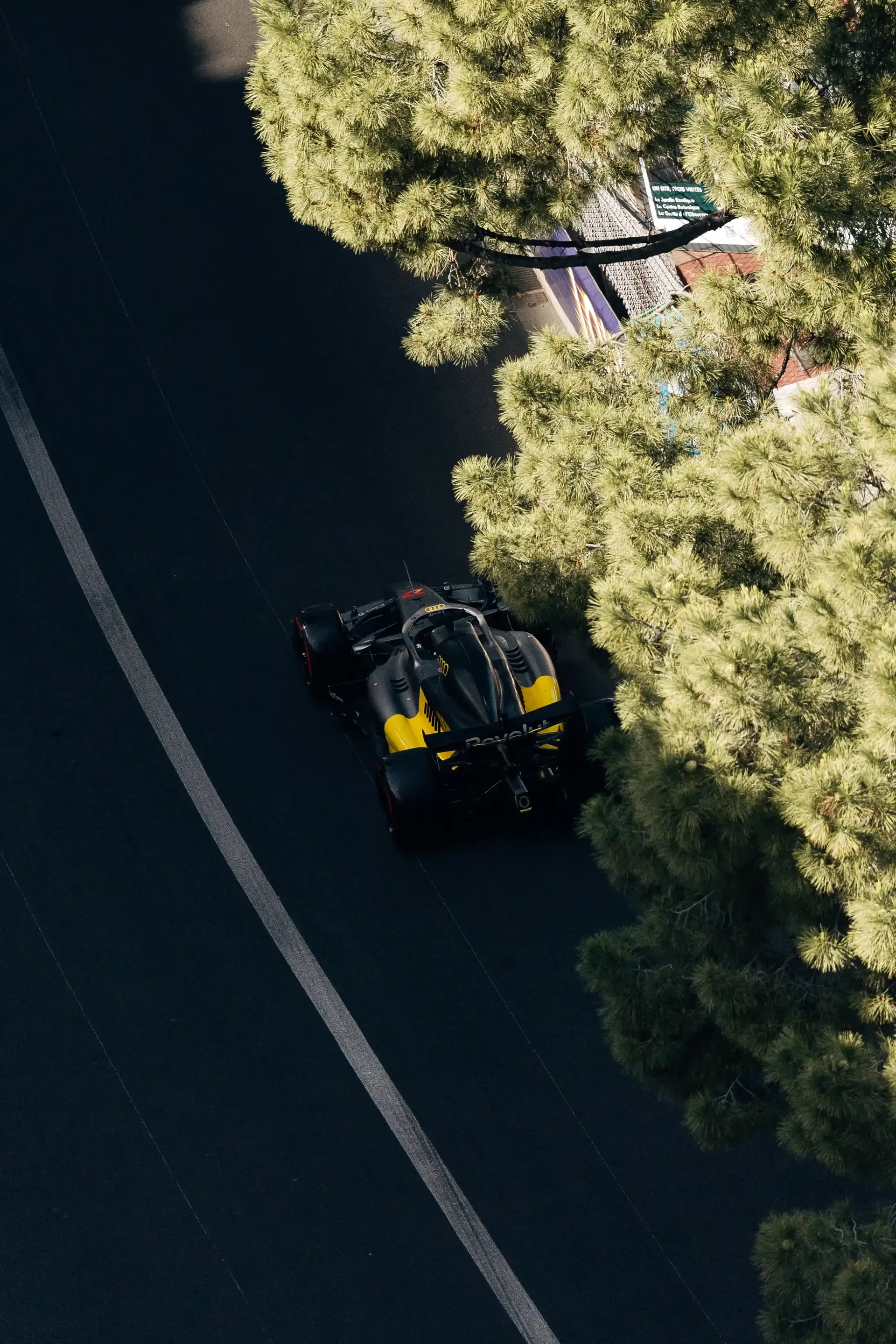 Audi Revolut F1® Team race car R26  drives along a tree-lined section of the Monaco street circuit during qualifying.